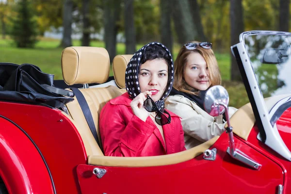 Women at car look interested and satisfied — Stock Photo, Image