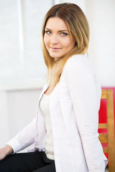 Mujer en estudio blanco sonrisa en la cámara — Foto de Stock