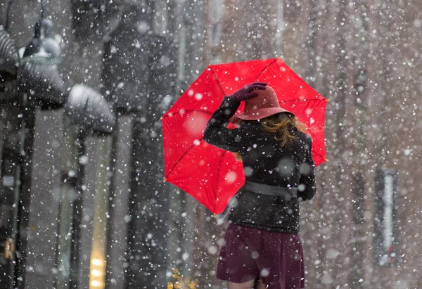 Woman try hold hat and umbrella — Stock Photo, Image