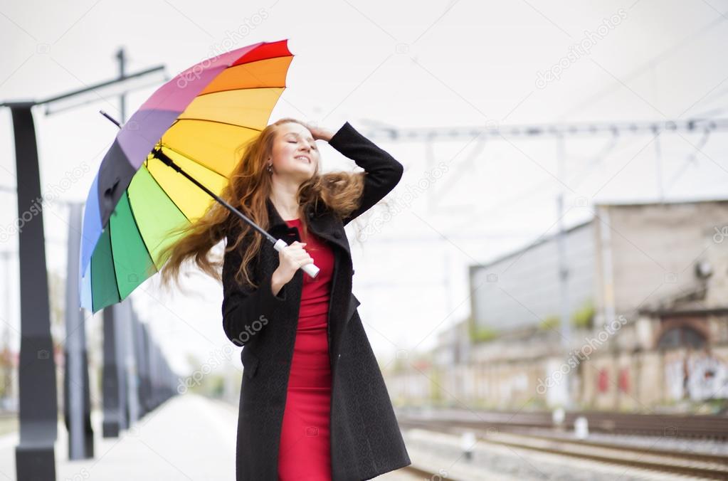 Woman with umbrella blowing long hair