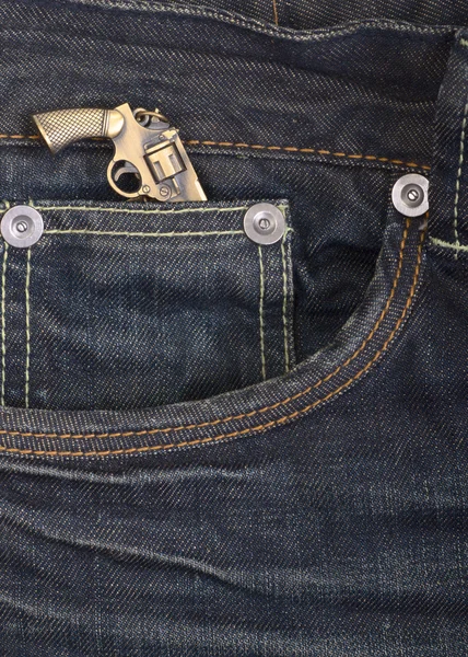 Dark blue denim jeans with a gun — Stock Photo, Image