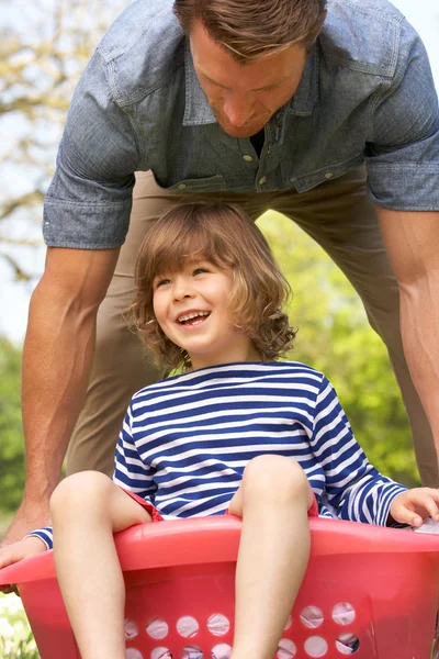 Father Carrying Son Sitting In Laundry Basket — Stock Photo, Image