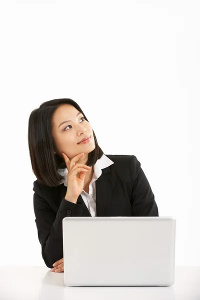 Studio Shot of Thoughtful Chinese Businesswoman Working On Lapto —  Fotos de Stock