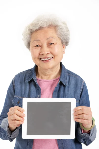 Studio Shot of Chinese Senior Woman Holding Digital Tablet — стоковое фото