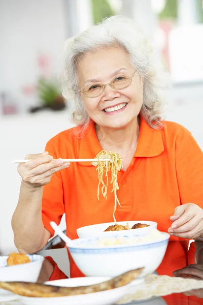 Senior cinese donna seduta a casa mangiare pasto — Foto Stock