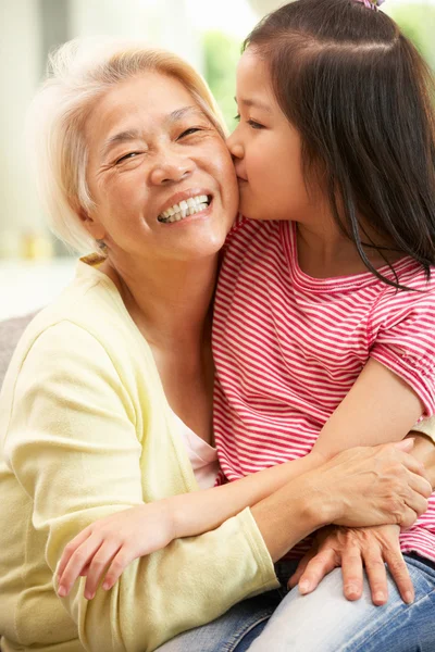 Chinese Grandmother And Granddaughter Relaxing On Sofa At Home — Stock Photo, Image