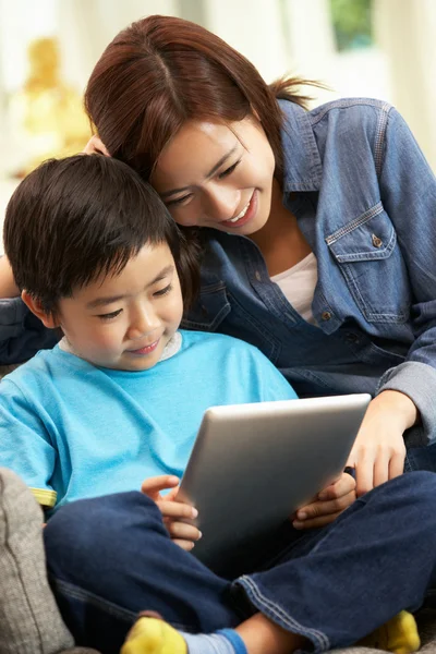 Chinese Mother And Son Using Tablet Computer Whilst Sitting On S — Stock Photo, Image