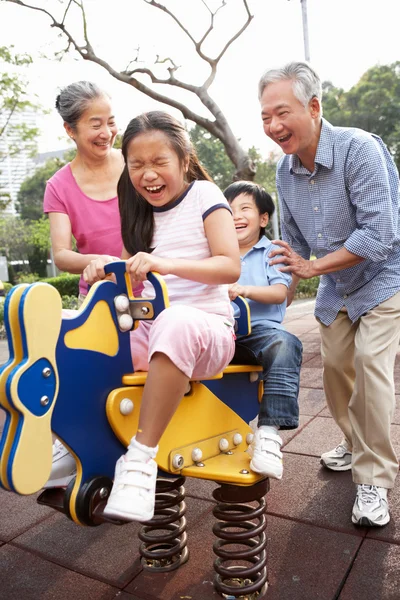 Chinese Grandparents Playing With Grandchildren In Playground — Stock Photo, Image