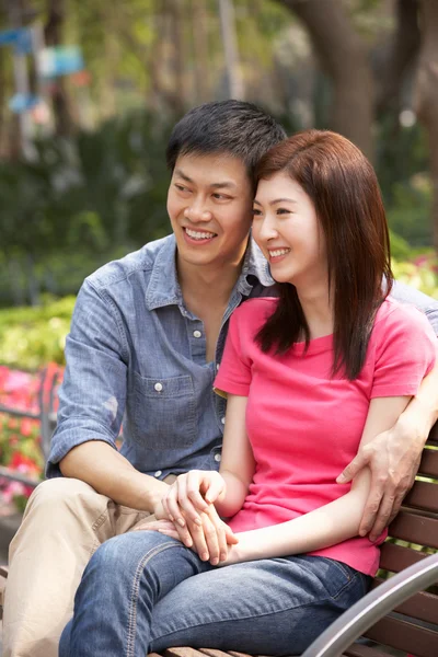 Young Chinese Couple Relaxing On Park Bench Together — Stock Photo, Image