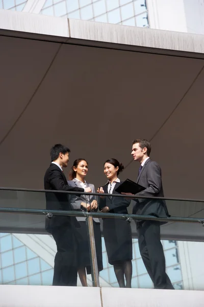 Quatre collègues d'affaires en discussion à l'extérieur de l'immeuble de bureaux — Photo