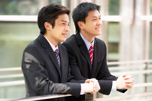 Two Chinese Businessmen Outside Modern Office Royalty Free Stock Photos