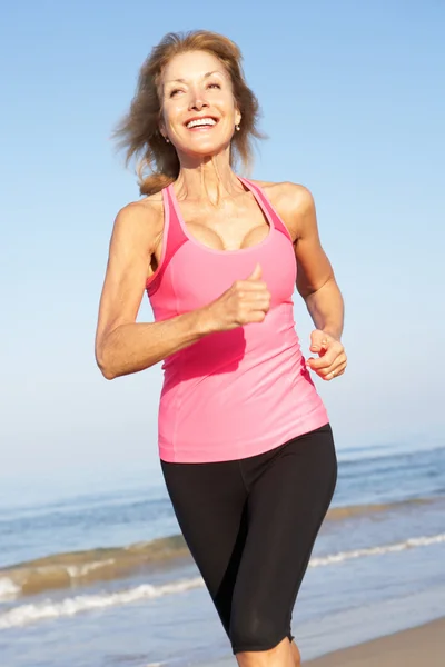 Senior Woman Exercising On Beach — Stock Photo, Image