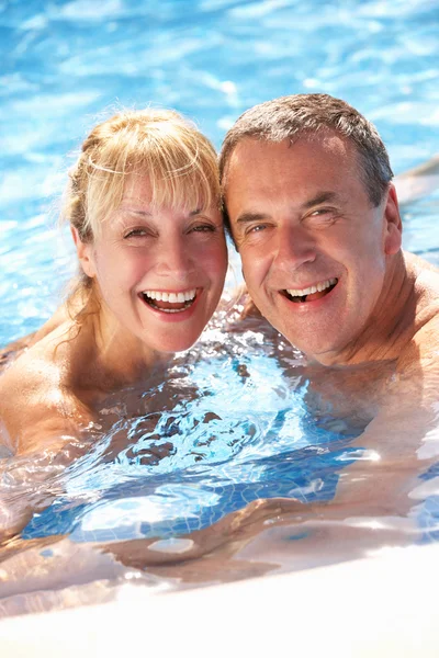 Старшая пара, развлекающаяся в бассейне — стоковое фото