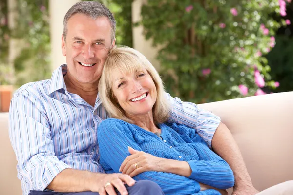 Senior Couple Relaxing On Sofa At Home — Stock Photo, Image