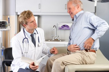 Doctor Examining Male Patient With Hip Pain clipart