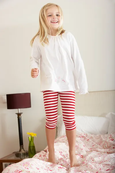 Young Girl Bouncing On Bed — Stock Photo, Image