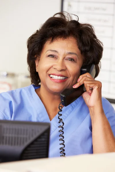 Nurse Making Phone Call At Nurses Station — Stock Photo, Image