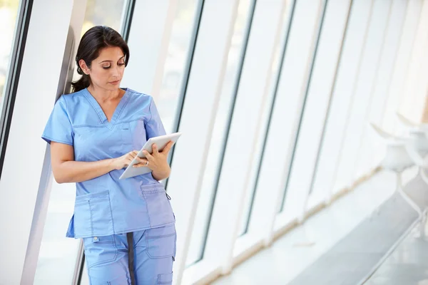 Enfermera usando tableta digital en el corredor del hospital moderno —  Fotos de Stock