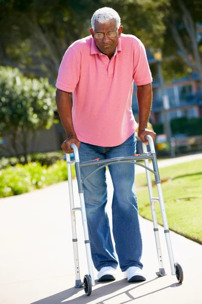 Äldre man med promenader ram — Stockfoto