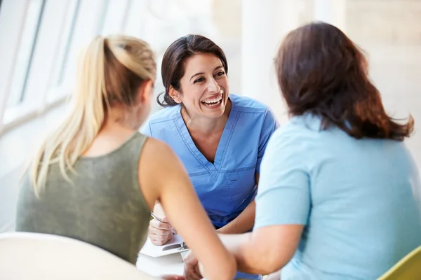 Enfermera reunión con adolescente chica y madre en el hospital — Foto de Stock