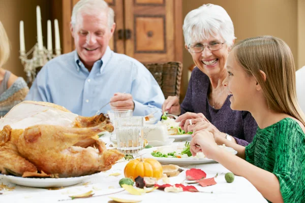 Granddaughter Celebrating Thanksgiving With Grandparents Stock Photo