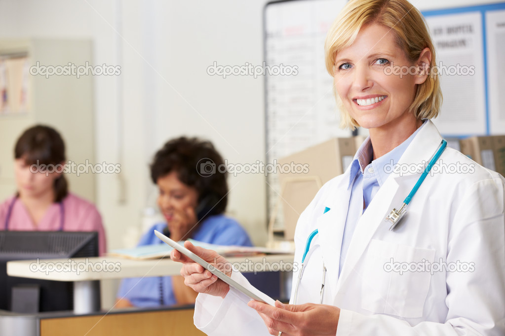 Mature Female Doctor With Tablet Computer On White Background Stock Photo