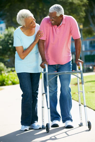 Senior Woman Helping Husband With Walking Frame — Stock Photo, Image