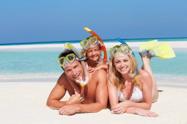 Family With Snorkels Enjoying Beach Holiday clipart