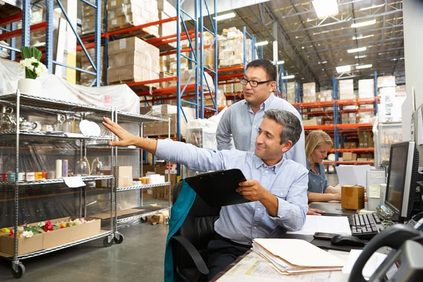 Business Colleagues Working At Desk In Warehouse — Stock Photo, Image