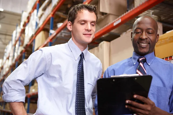 Two Businessmen With Clipboard In Warehouse — Stock Photo, Image