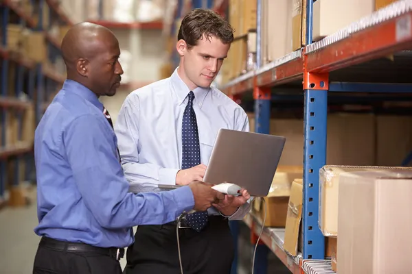 Two Businessmen With Laptop In Warehouse — Stock Photo, Image