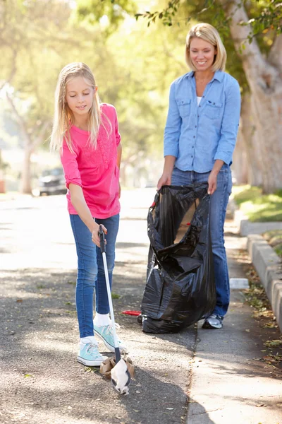 Madre e figlia pick up litter in Suburban street — Foto Stock