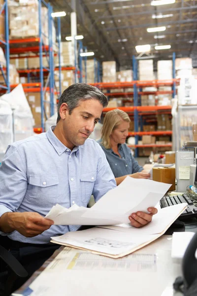 Business Colleagues Working At Desk In Warehouse — Stock Photo, Image