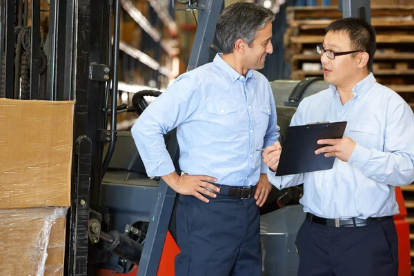 Businessmen Meeting By Fork Lift Truck In Warehouse — Stock Photo, Image