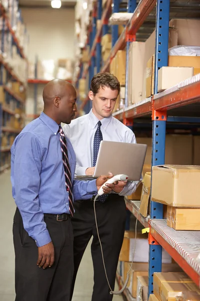 Two Businessmen With Laptop In Warehouse — Stock Photo, Image