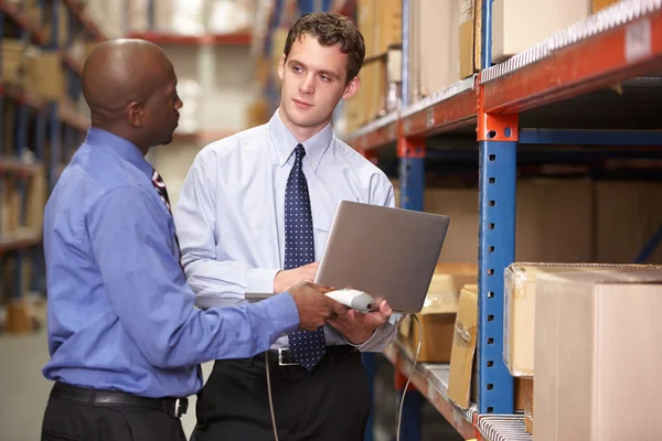 Two Businessmen With Laptop In Warehouse — Stock Photo, Image