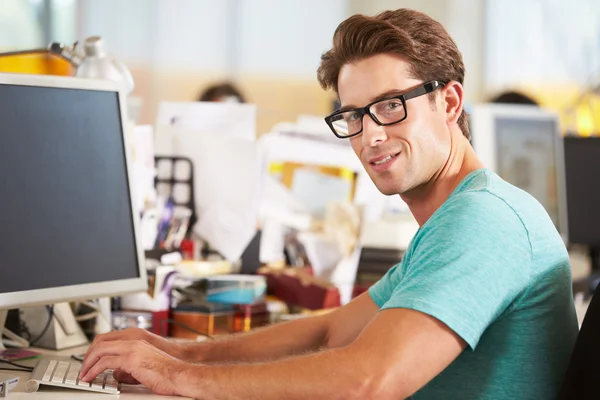Man Working At Desk In Busy Creative Office — Stock Photo, Image