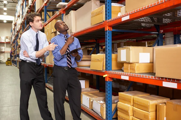 Two Businessmen With Clipboard In Warehouse — Stock Photo, Image