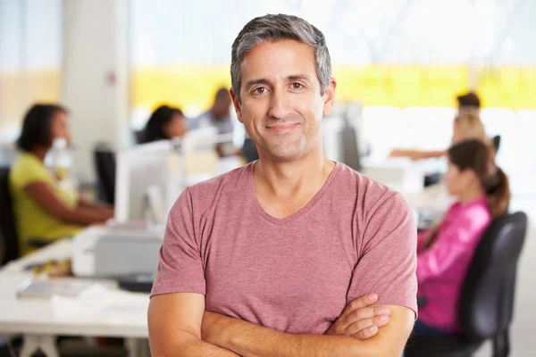 Portrait Of Man Standing In Busy Creative Office — Stock Photo, Image