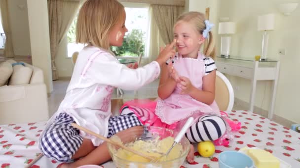 Two girls tasting cake mixture — Stock Video