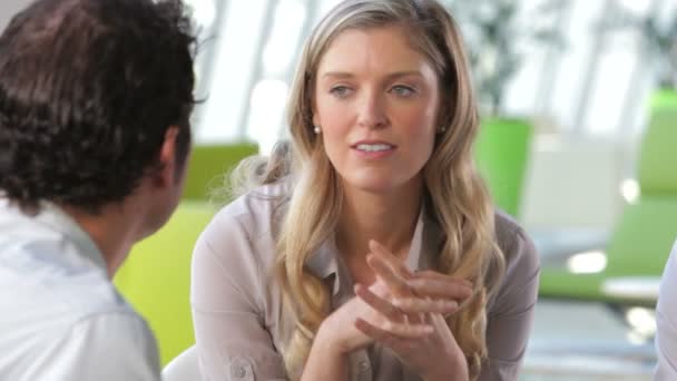 Businessman talking to female colleague in office. — Stock Video