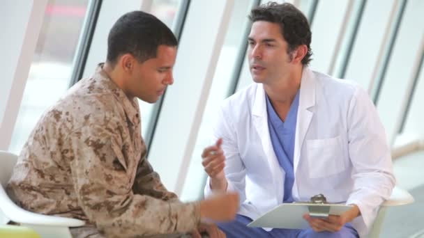 Doctor comforts soldier in uniform suffering from post traumatic stress disorder. — Stock Video
