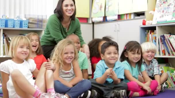 Group Of Students Sitting On Floor With Teacher Stock Video