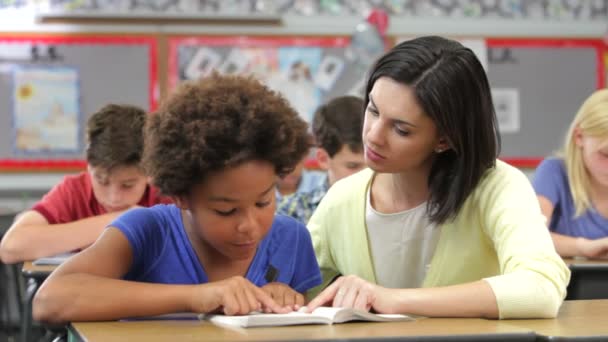 Onderwijzer en student samen lezen. — Stockvideo