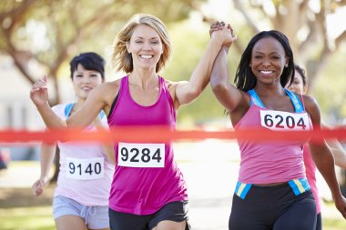 Two Female Runners Finishing Race Together clipart