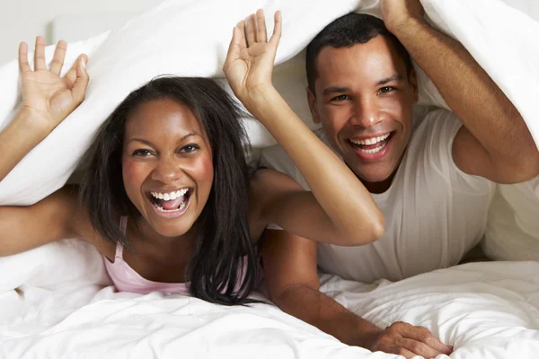 Couple Relaxing In Bed Hiding Under Duvet — Stok fotoğraf