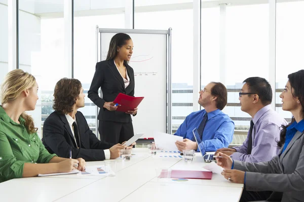 Businesswoman Conducting Meeting In Boardroom — Stock Photo, Image