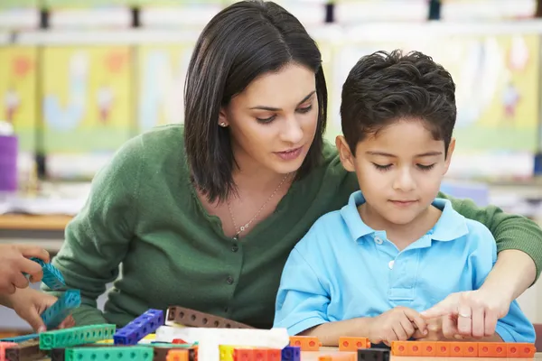 Elementary Pupil Counting With Teacher In Classroom — Stock Photo, Image