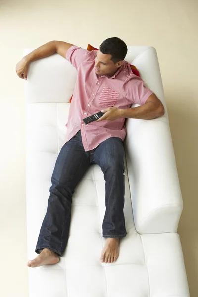 Visão aérea do homem relaxando no sofá assistindo televisão — Fotografia de Stock