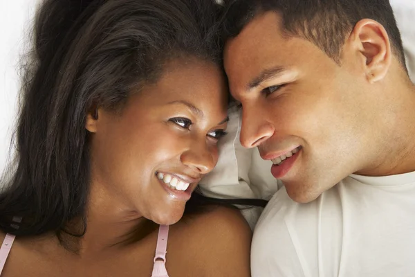 Couple Relaxing In Bed Wearing Pajamas — Stockfoto